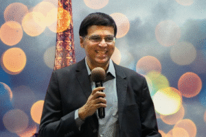 a man holding a microphone is viswanathan-anand