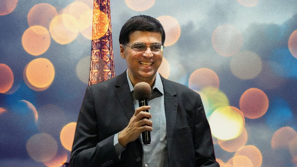 a man holding a microphone is viswanathan-anand